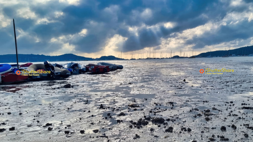 Boats on Muddy Shore at Sunrise