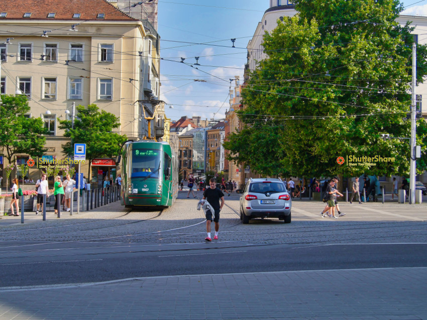 Vibrant City Street with Tram and Pedestrians